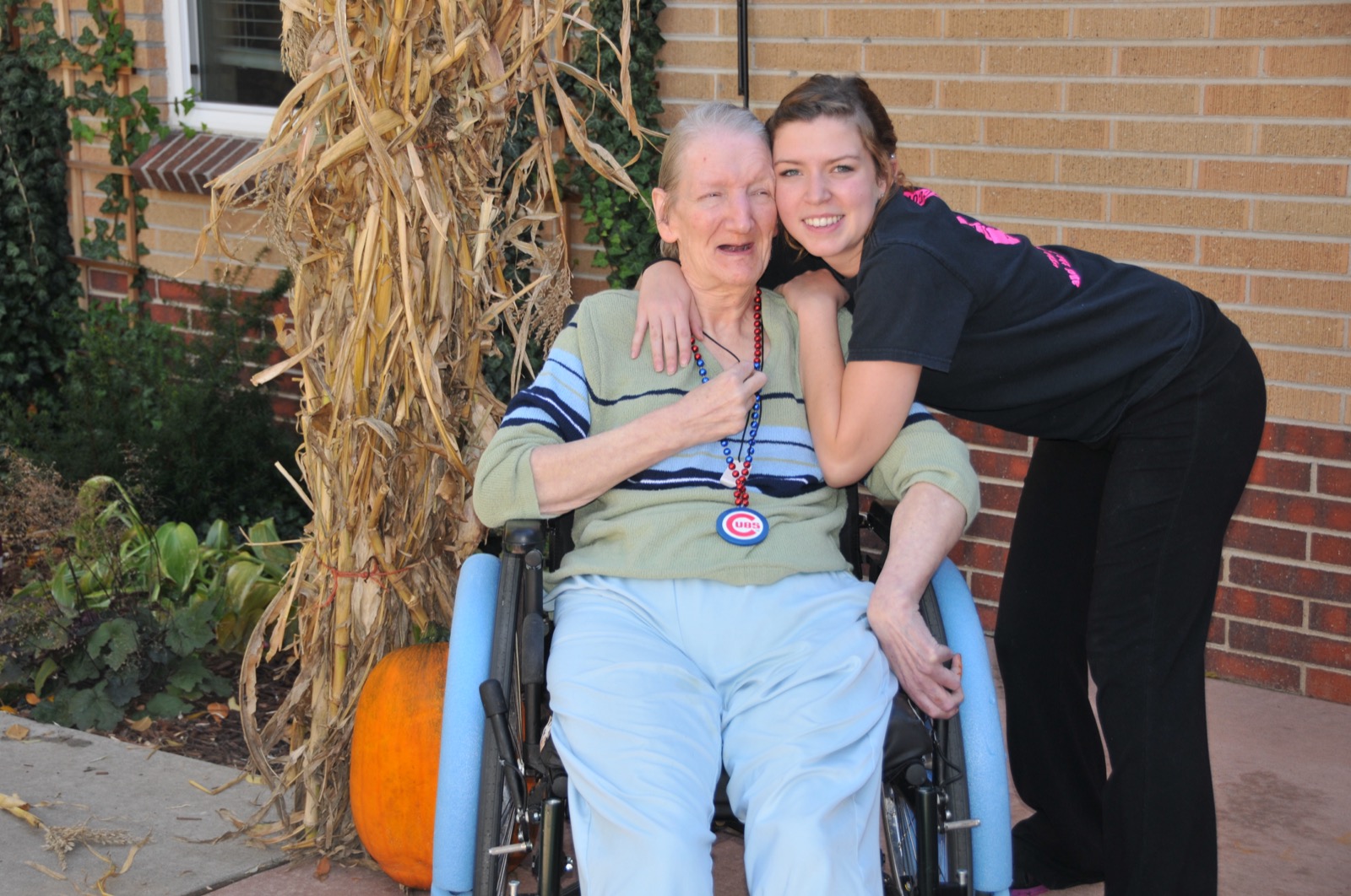 Caregiver embracing a senior client outdoors